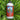 Bottle of Neptune's Harvest Tomato & Veg fertilizer on a bed of healthy green leaves