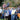 Group of home gardeners lined up along an orange truck