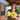 Gardener on farm porch with an armful of yellow Y-star squash