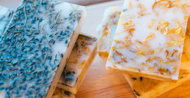 Homemade herbal soaps with lavender and calendula inclusions.