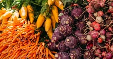 Huge bunches of carrots, radishes, and turnips