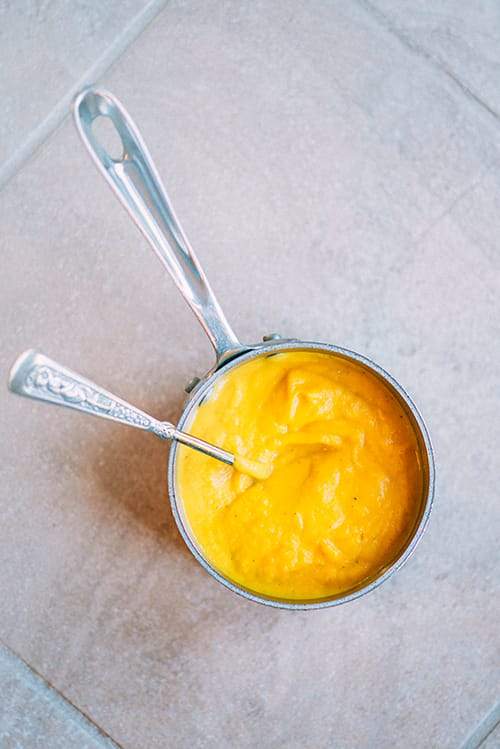 pumpkin puree in pan with spoon top view
