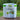 White and green countertop compost bin with 50 compost bags on a table with natural background.