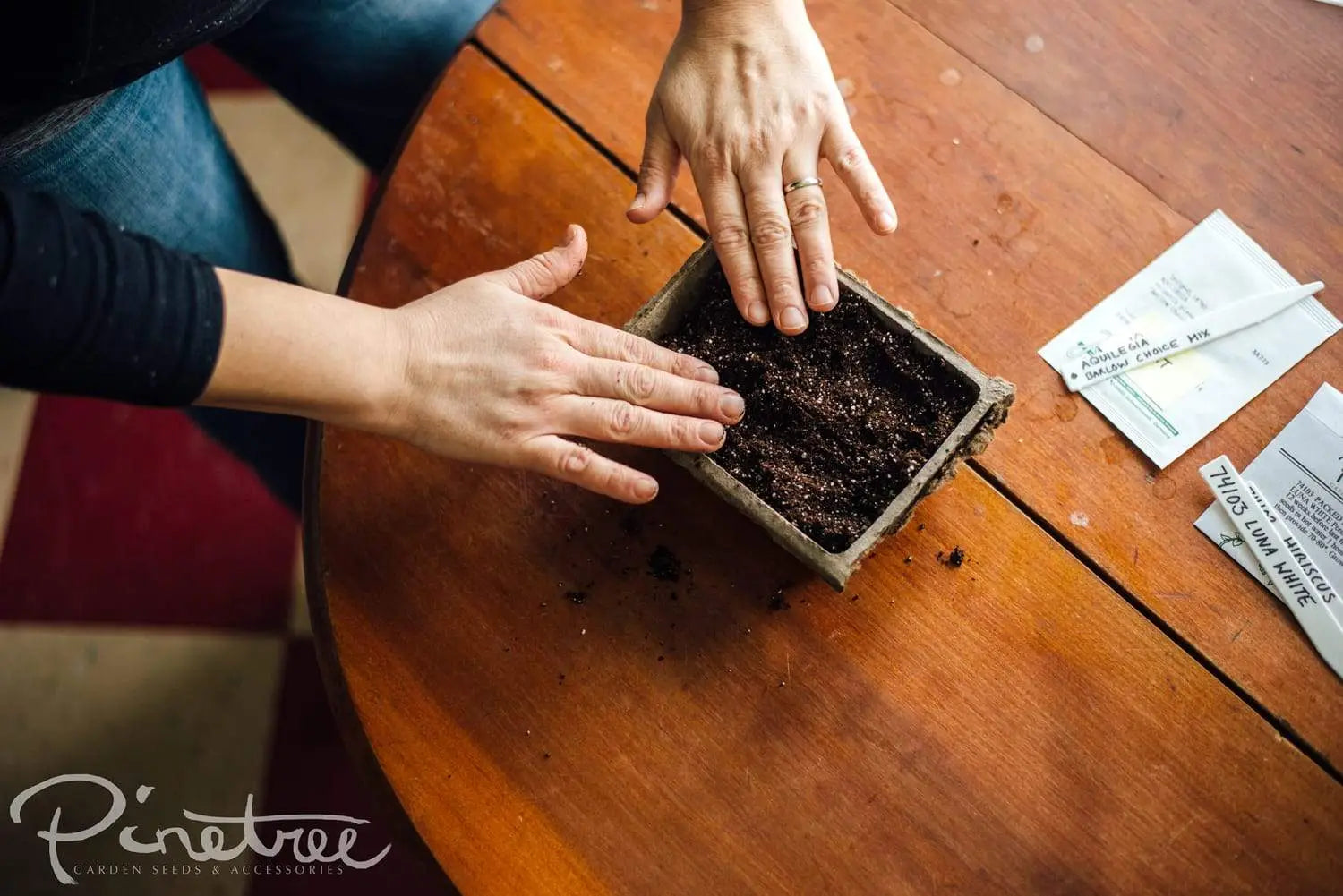 Gardener filling fiber pack with pre moistened soil
