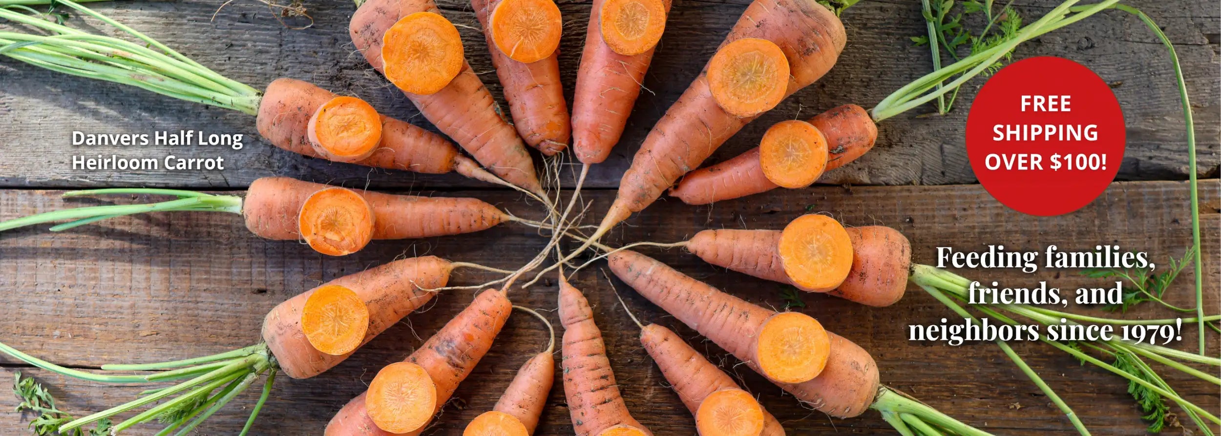 Oranges carrots with green tops arranged in a circular pattern on a wooden surface.